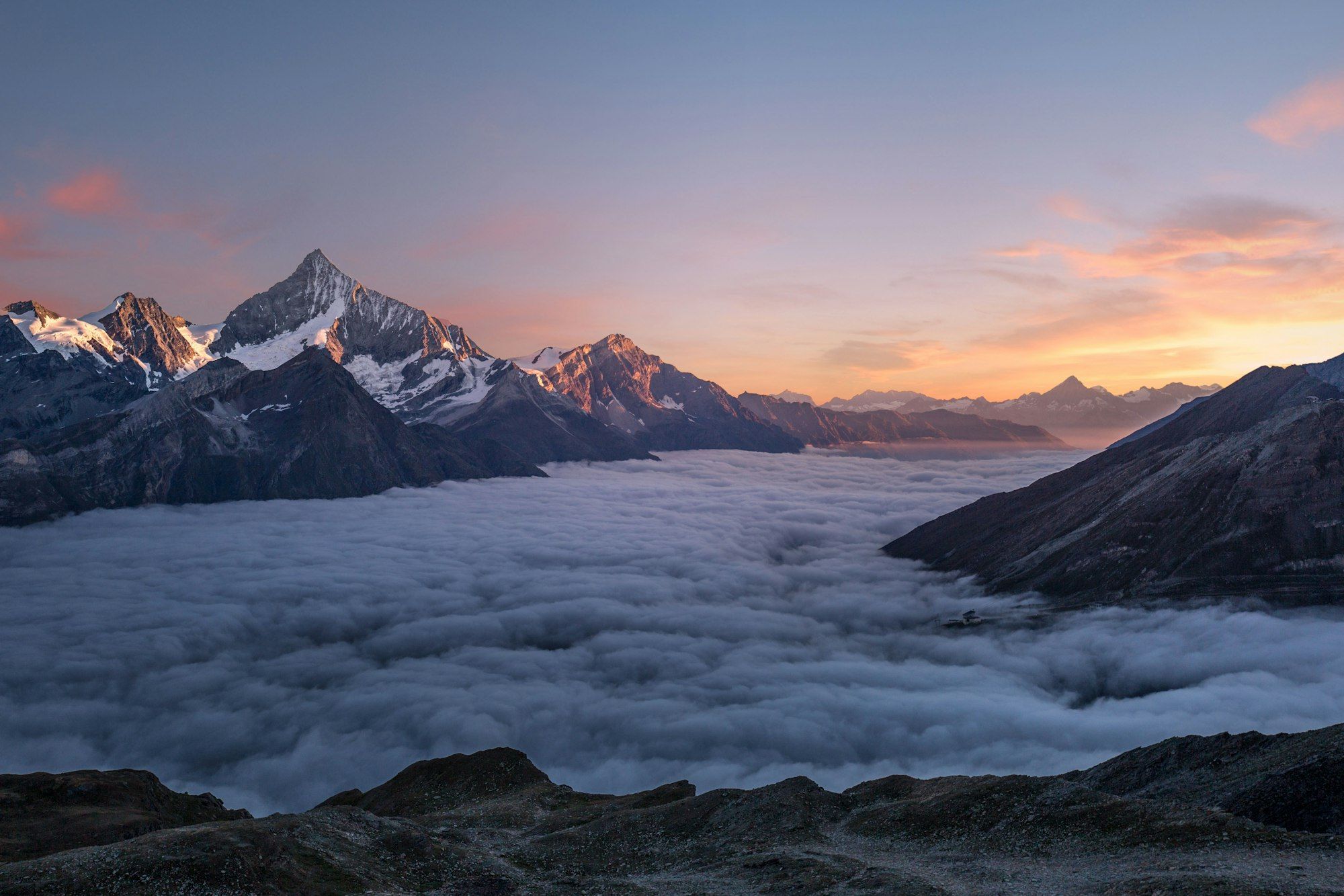 Mountain peaks rising above a sea of clouds